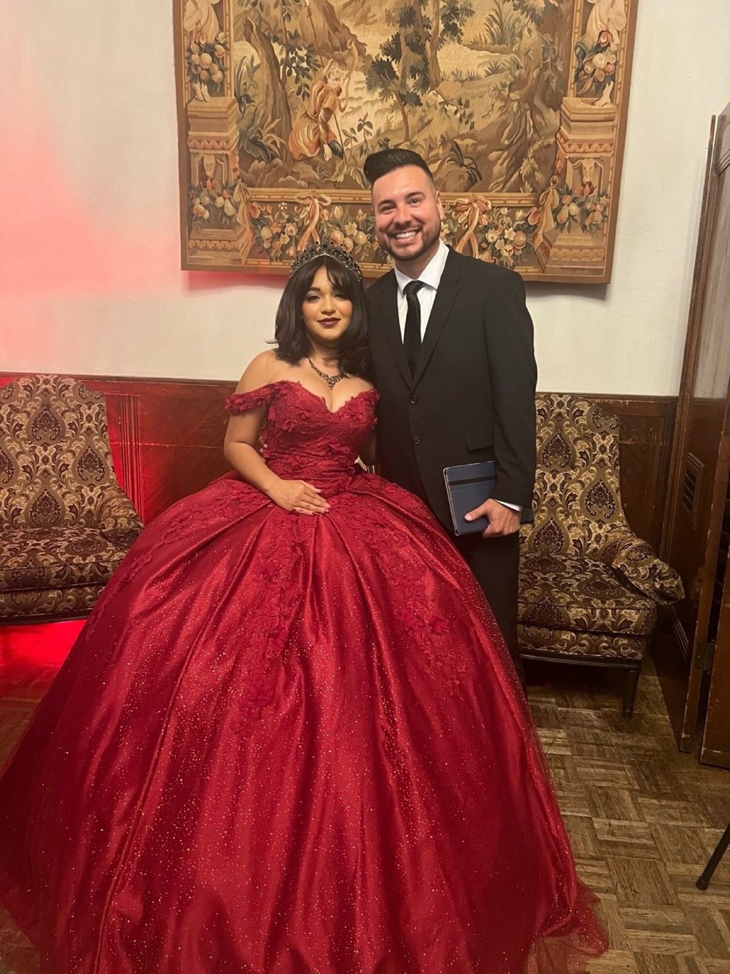 Mr. Mark standing with a quinceañera celebrant at a formal event