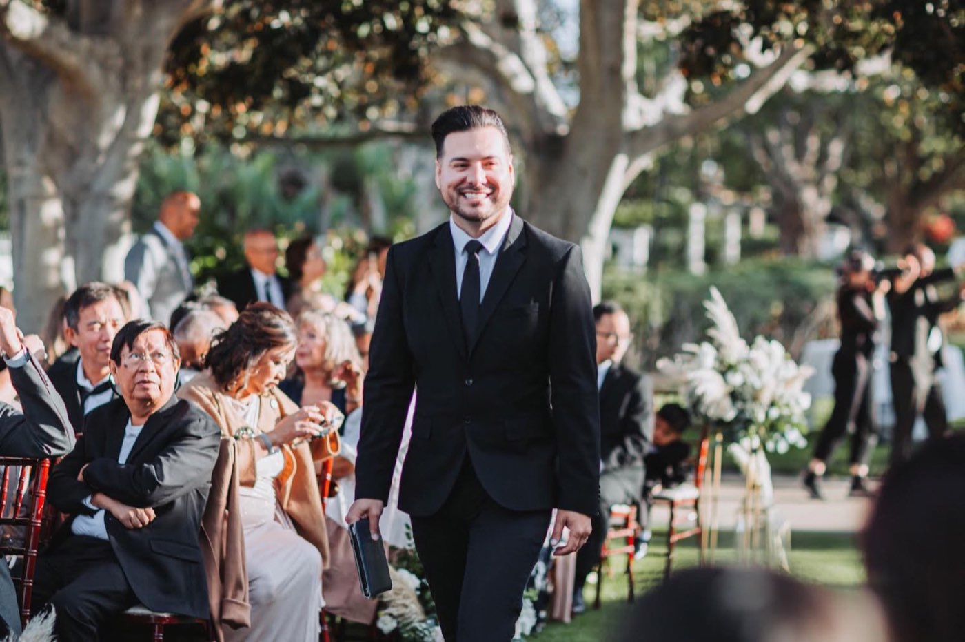 Mr. Mark walking down the aisle at a real ceremony